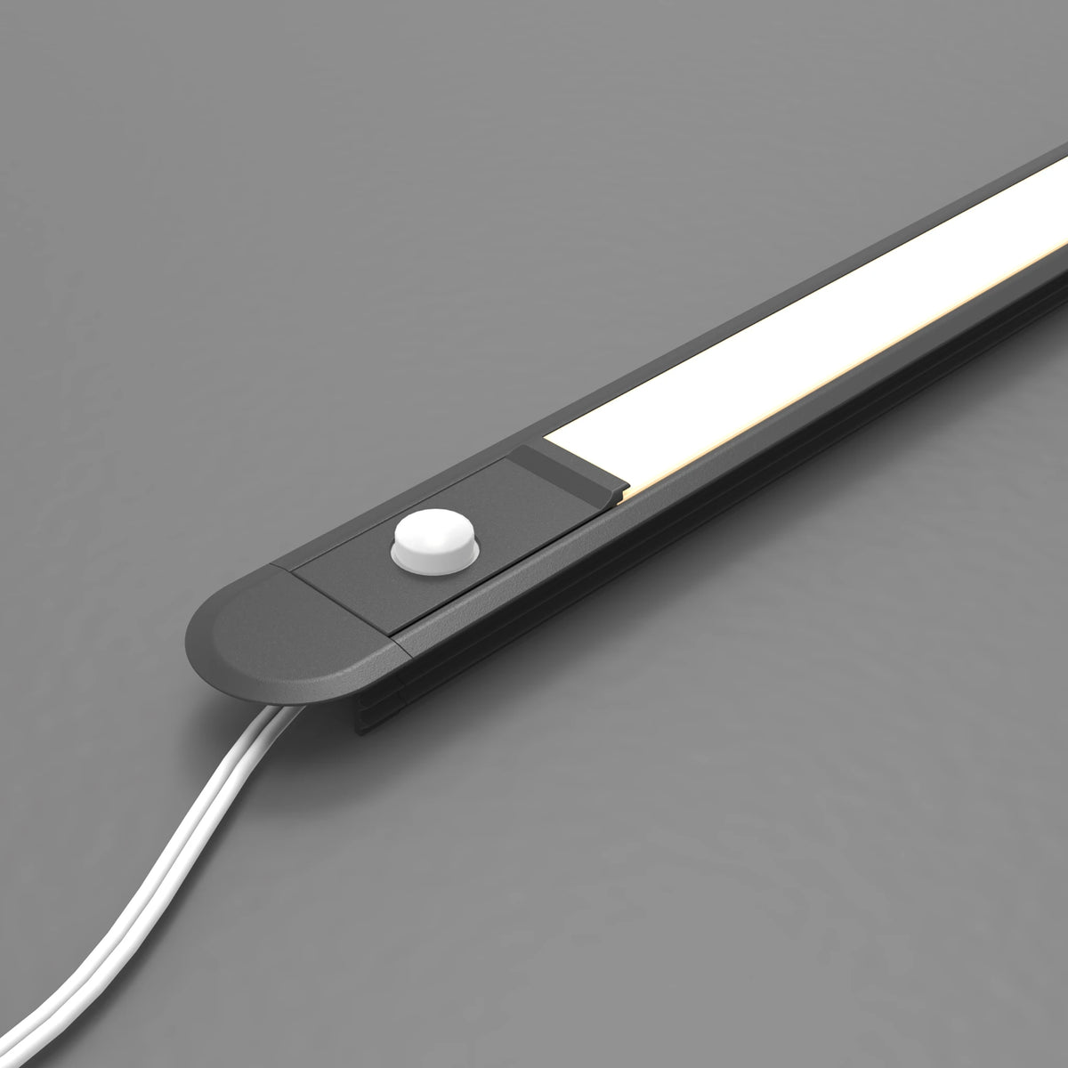 A slim black LED light bar with a white button control and white power cord, shown on a neutral gray background. #Finish_Black