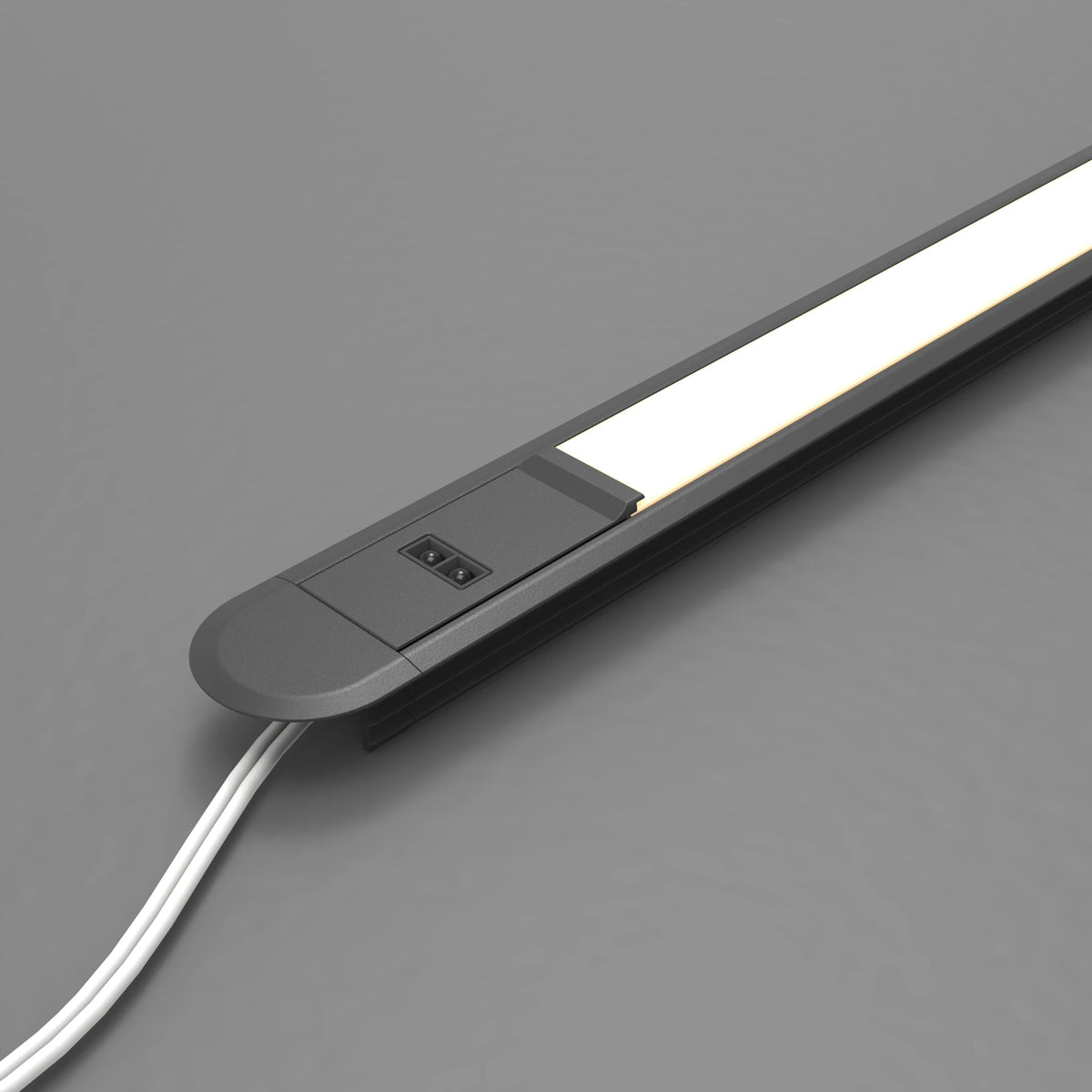 A slim rectangular LED light bar with a matte black housing, featuring a power switch and a white power cord, shown on a neutral gray background. #Finish_Black